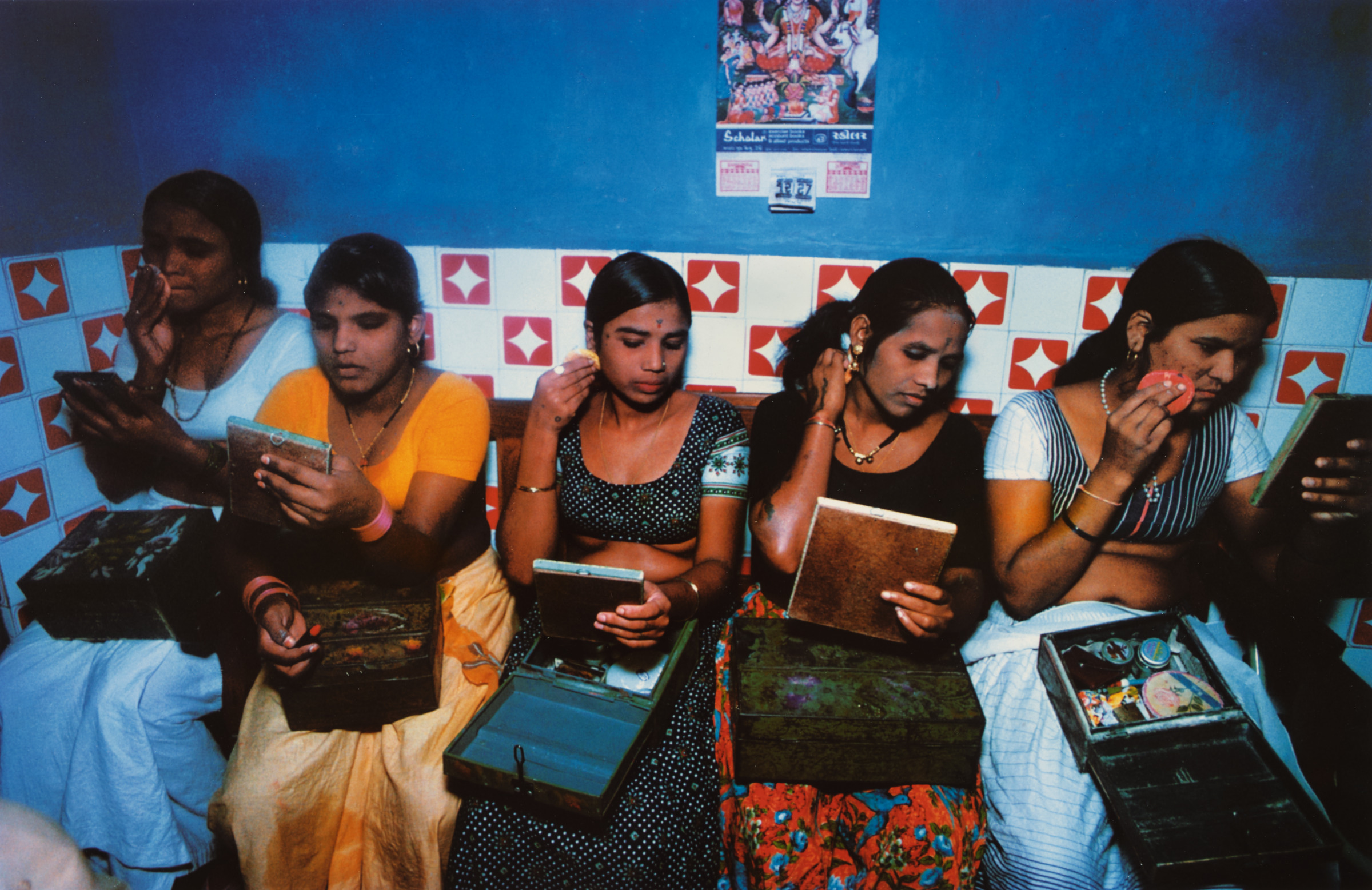 Five girls with their make-up boxes prepare for the evening