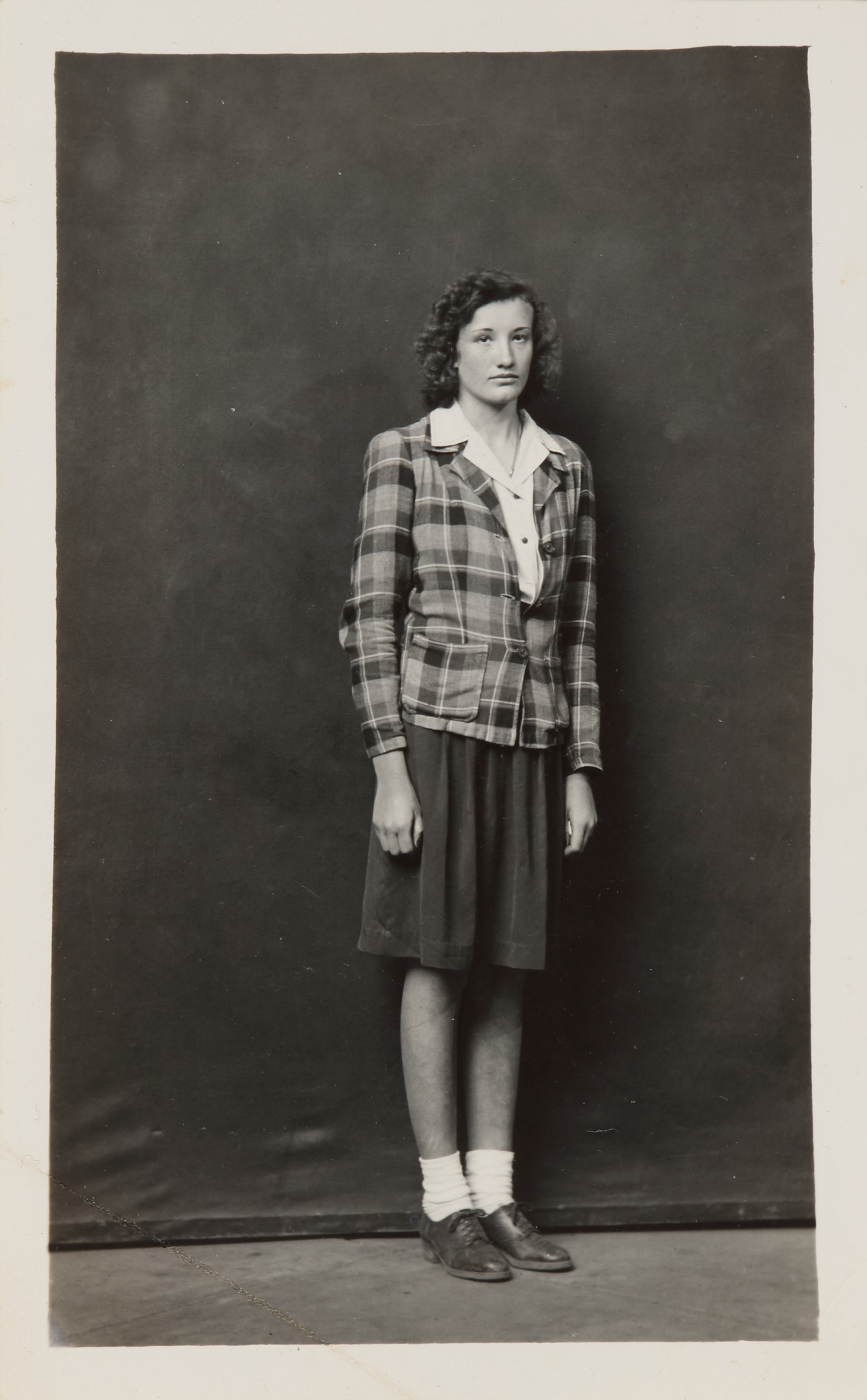 Standing Woman in Plaid Jacket