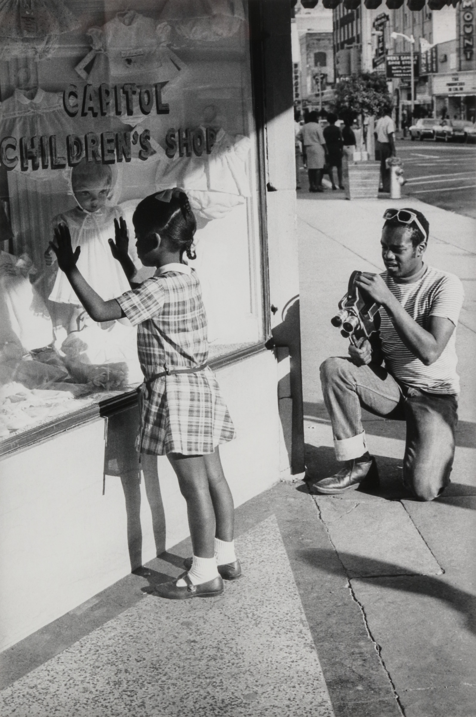 Member of Southern Media photographing a young girl, Farish Street, Jackson, Mississippi