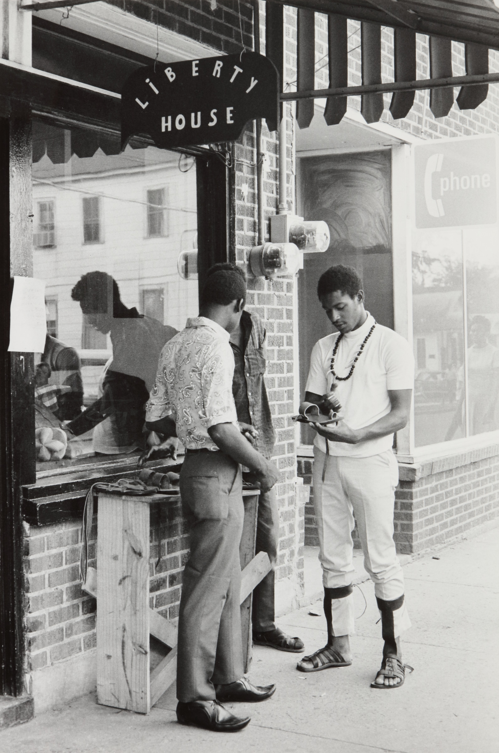 Liberty House Cooperative worker displaying leather goods Farish Street, Jackson, Mississippi